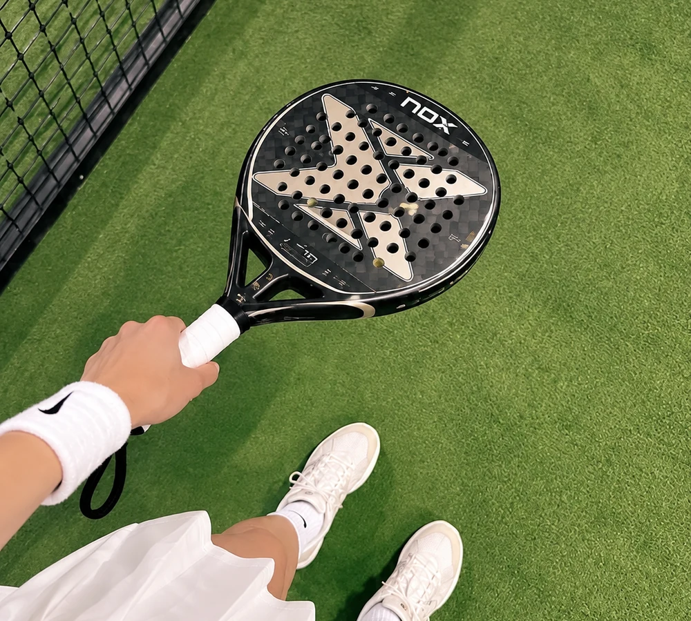 Padel racket and court detail at OLA.