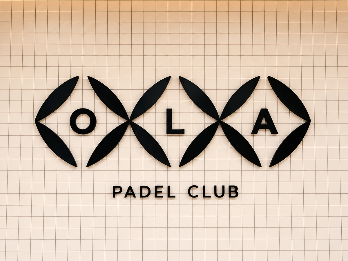 OLA Padel Club physical brand wall.